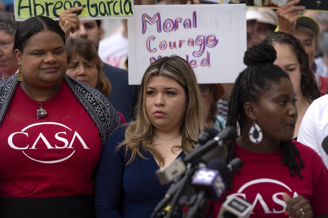 Jennifer Vasquez Sura, center, the wife of Kilmar Abrego Garcia, joins supporters of Abrego Garcia as they rally outside of the U.S. District Court in Greenbelt, Md., where a hearing was scheduled to be held on returning him to Maryland, Monday, July 7, 2025. (AP Photo/Mark Schiefelbein)
