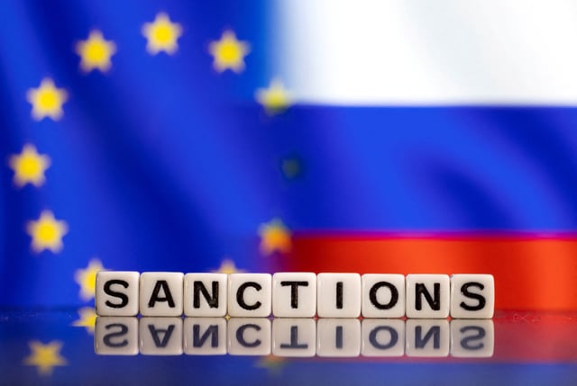 Plastic letters arranged to read "Sanctions" are placed in front of EU and Russia's flag colors in this illustration taken February 25, 2022. REUTERS/Dado Ruvic/Illustration/File Photo