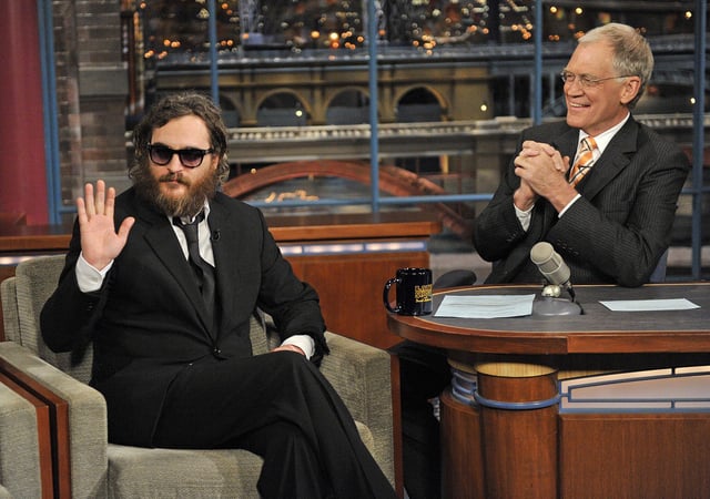 Actor Joaquin Phoenix, waves to the audience during his interview with Late Show host David Letterman during the Late Show with David Letterman Wednesday, February 11, 2009 on the CBS Television Network.