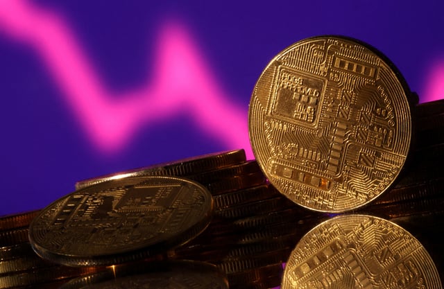 Representations of cryptocurrencies are seen in front of displayed decreasing stock graph in this illustration taken November 10, 2022. REUTERS/Dado Ruvic/Illustration