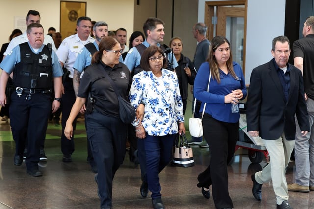 Rocio Lasso, center, the mother of slain Chicago police Officer Andrés Mauricio Vásquez Lasso, walks through the lobby of the Leighton Criminal Court Building on July 15, 2025, during a break in the trial of her son’s accused killer. (Terrence Antonio James/Chicago Tribune)