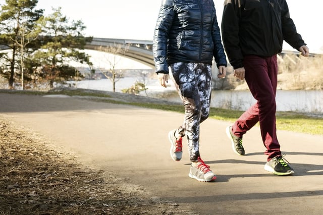 Maintaining good form by standing tall and swinging your arms is key when walking.