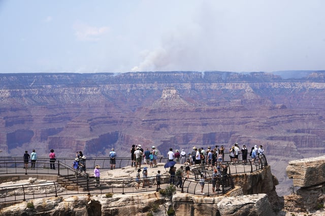 Smoke from the Dragon Bravo Fire can be seen by visitors as it burns on the Grand Canyon's North Rim on July 15, 2025.