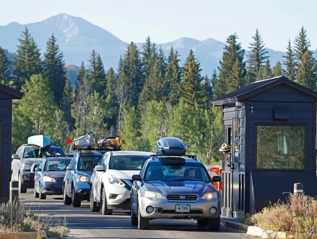 Cars line up at the south entrance to Grand Teton National Park on August 19, 2017 outside Jackson, Wyoming.