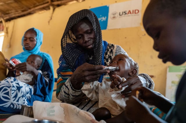 Rahma Kaki Jubarra and her sons, who are emergency level malnourished, Farah, 9 months and Jabr, three and a half, receive aid at Almanar feeding center in Mayo Mandala on the outskirts of Omdurman, Sudan, on May 25, 2025.