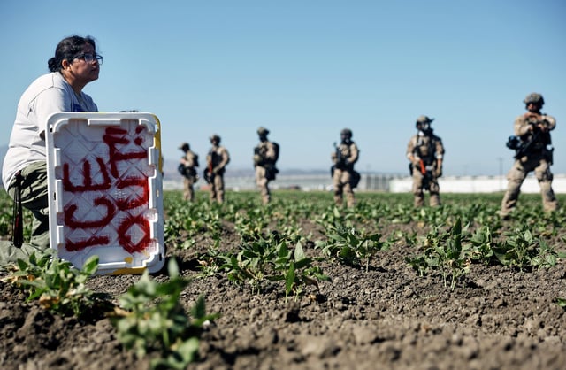 FILE: Federal agents block people protesting an ICE immigration raid at a nearby licensed cannabis farm on July 10, 2025, near Camarillo, Calif.