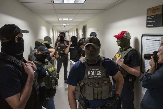 Federal agents stand outside immigration court at the Jacob K. Javits Federal Building, Wednesday, July 16, 2025, in New York. (AP Photo/Yuki Iwamura)