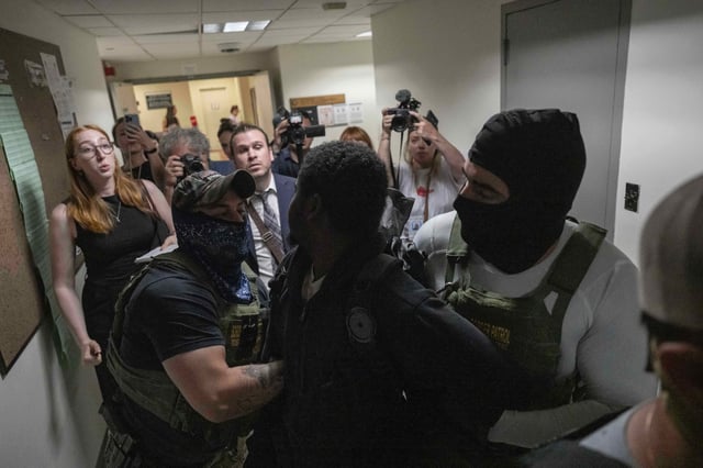 A person is detained by federal agents outside an immigration court at the Jacob K. Javits federal building on Thursday, July 3, 2025, in New York. (AP Photo/Yuki Iwamura)