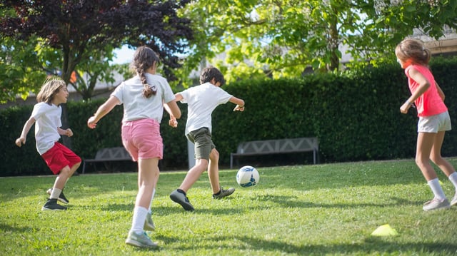 A group of children playing football together. Image: Pexels