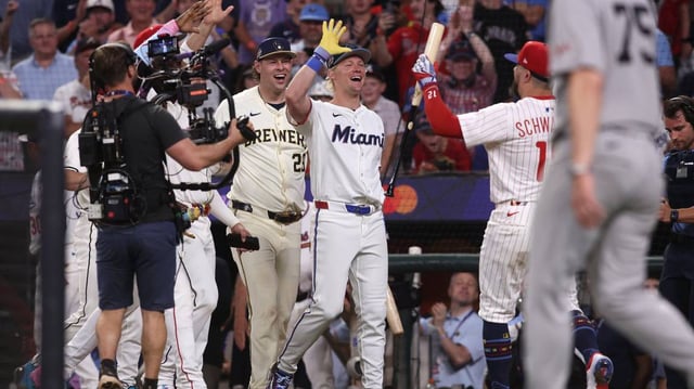 National League designated hitter Kyle Schwarber celebrates with teammates after hitting three home runs in the All-Star Game “swing off” to beat the American League on Tuesday night.