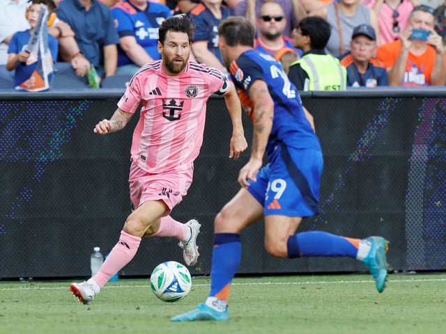 Inter Miami's Lionel Messi, left, dribbles the ball as FC Cincinnati's Lukas Engel defends during the first half of an MLS soccer match, Wednesday, July 16, 2025, in Cincinnati. (AP Photo/Jay LaPrete)