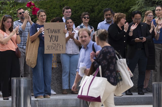 State Department employees applaud as their colleagues walk outside of the State Department headquarters in the Harry S Truman Building, Friday, July 11, 2025, in Washington. (AP Photo/Manuel Balce Ceneta)