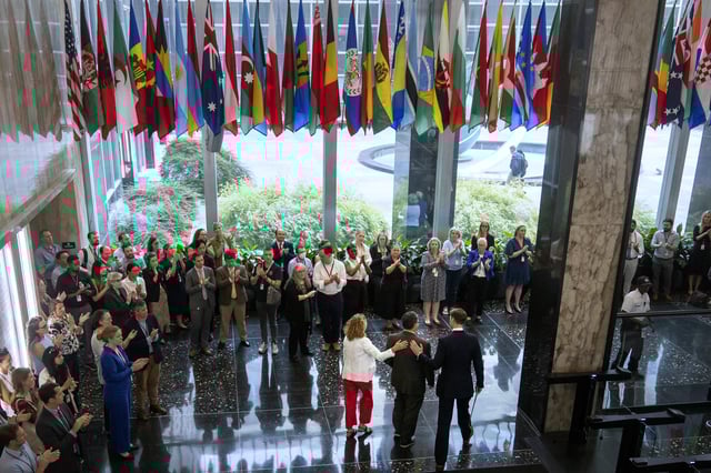 State Department employees applaud as their colleagues walk through the lobby of the State Department headquarters in the Harry S. Truman Building, Friday, July 11, 2025, in Washington. (AP Photo/Mark Schiefelbein).