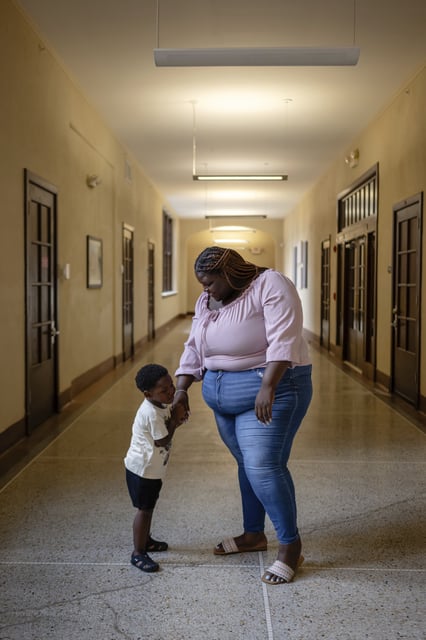 Aaliyah and Aarmoni Barnes stand in the hallway near their apartment at the Stoddard Johnston Scholar House, Friday, July 11, 2025, in Louisville, Ky. (AP Photo/Jon Cherry)
