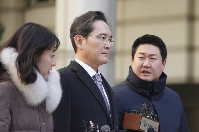 FILE - Samsung Electronics Chairman Lee Jae-yong, center, is questioned by reporters as he leaves the Seoul High Court in Seoul, South Korea, on Feb. 3, 2025. (AP Photo/Lee Jin-man)