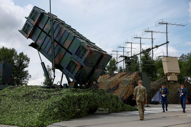 Ukrainian service members walk next to a launcher of a Patriot air defence system, amid Russia's attack on Ukraine, in an undisclosed location, Ukraine August 4, 2024. REUTERS/Valentyn Ogirenko/File Photo