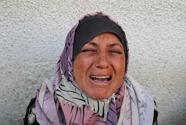 A woman reacts during the funeral of Palestinians killed in overnight Israeli strikes, according to medics, at Al-Shifa hospital in Gaza City, July 17, 2025. REUTERS/Mahmoud Issa