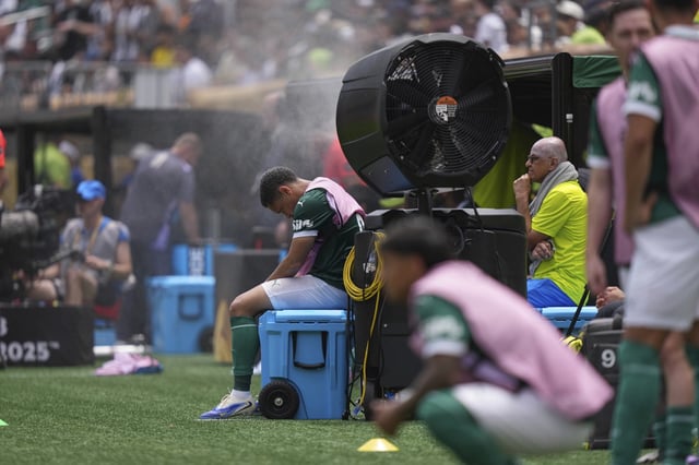 FILE - Palmeiras' Vitor Roque sits on the side of the pitch in a cooling mist after being substituted during the Club World Cup round of 16 soccer match between Palmeiras and Botafogo in Philadelphia, Sunday, June 29, 2025. (AP Photo/Matt Slocum, File)