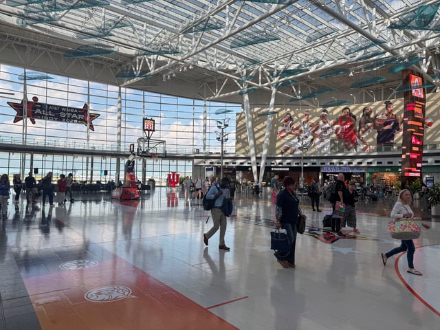People walk by a replica WNBA court inside the Indianapolis International Airport, in Indianapolis, Indiana, U.S. July 16, 2025. REUTERS/Amy Tennery