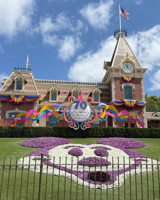 A Mickey Mouse topiary display welcomes guests to the entrance to Disneyland Park for its 70th anniversary.