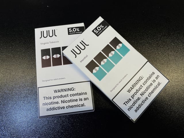 Juul e-cigarettes are seen on the counter of a vape store in Santa Monica, California, U.S., June 23, 2022. REUTERS/Lucy Nicholson/File Photo
