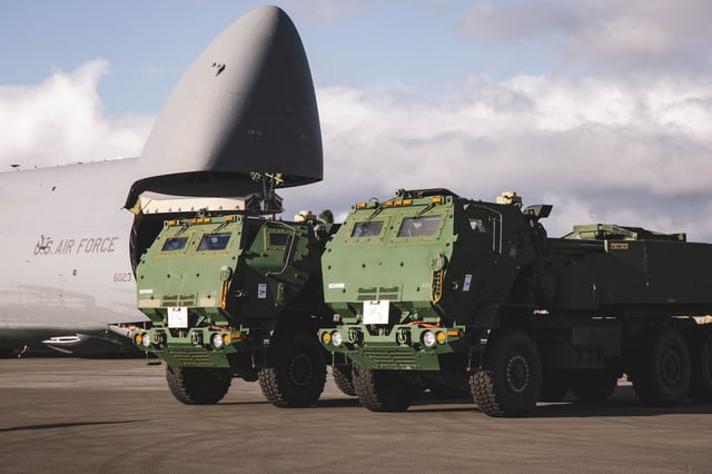 High Mobility Artillery Rocket System (HIMARS) launchers assigned to the United States Army 25th Infantry Division are staged on the flight line after being unloaded from a C-5 transport aircraft at Joint Base Pearl Harbor-Hickam in Hawaii on July 14, 2025.