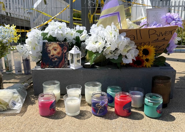 Flowers sit at a makeshift memorial in front of the Gabriel House assisted living facility, where a fire on Sunday killed several people, Wednesday, July 16, 2025 in Fall River, Mass. (AP Photo/Rodrique Ngowi)