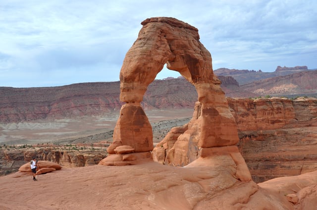 A visitor to Arches National Park near Moab, Utah, photographs the park&#39;s best known attraction, Delicate Arch.
