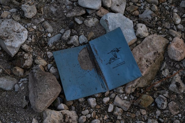 A copy of &#34;The Hunt for the Whooping Cranes&#34; sits on the bank of the Guadalupe River across from Camp Mystic, Monday, July 7, 2025, in Hunt, after a flash flood swept through the area. 