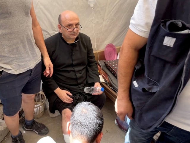 Parish priest of the Church of the Holy Family,  father Gabriele Romanelli, receives medical attention, after he suffered light leg injuries following an Israeli strike on the church, according to medics, at Al-Ahli Arab Hospital in Gaza City, in this still image taken from a video July 17, 2025. REUTERS/Dawoud Abu Alkas     TPX IMAGES OF THE DAY
