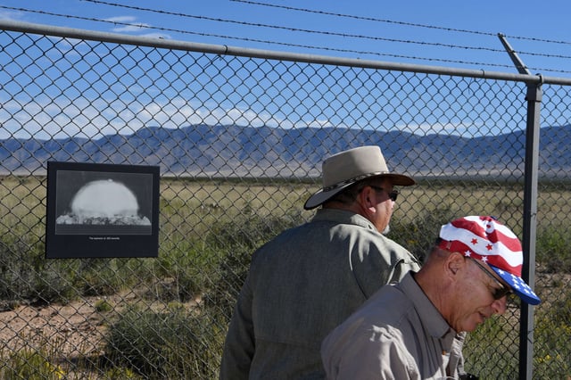 A photograph hangs on a fence at the Trinity Site at White Sands Missile Range in New Mexico, on October 15, 2022. Trinity is where the first atomic bomb was tested in July 1945.