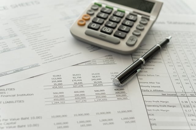 accounting business concept. pen, calculator, financial statement on accountant's desk.