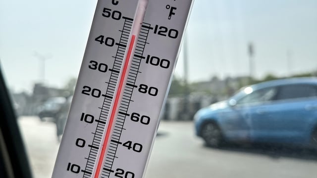 Thermometer rising in a hot car.
