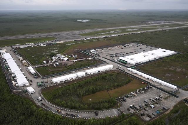 Work progressed on a new migrant detention facility dubbed "Alligator Alcatraz," at Dade-Collier Training and Transition facility in the Florida Everglades, Friday, July 4, 2025, in Ochopee, Fla. (AP Photo/Rebecca Blackwell)