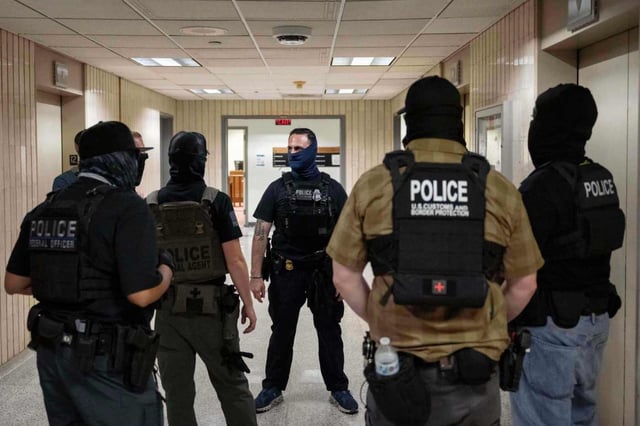 Federal agents stand outside an immigration court at the Jacob K. Javits federal building in New York on Thursday, July 17, 2025. (AP Photo/Yuki Iwamura)