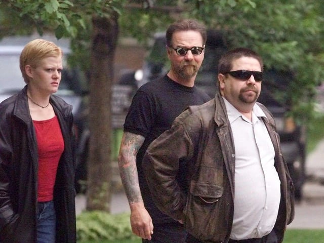  Former Calgary Hells Angels president Kenneth Szczerba walks away from the Court of Queens Bench with some supporters during a break in proceedings prior to sentencing on Friday.