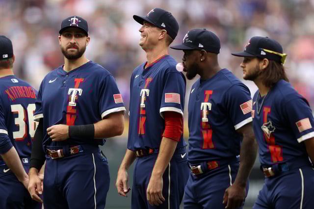 Kyle Gibson #44 of the Texas Rangers laughs during player introductions ahead of the 91st MLB All-Star Game at Coors Field on July 13, 2021 in Denver, Colorado.