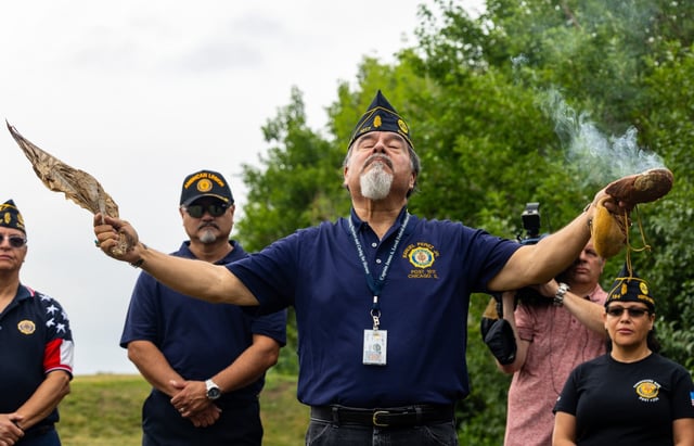 George R. Gandara, a Marine Corps League chaplain and member of the indigenous Yaqui tribe, offers prayers and blessings through a tribal tradition during a memorial to honor World War II veteran and prisoner of war Emilio Aguirre with a new headstone and full military honors, July 17, 2025, at Homewood Memorial Gardens cemetery. (Dominic Di Palermo/Chicago Tribune)