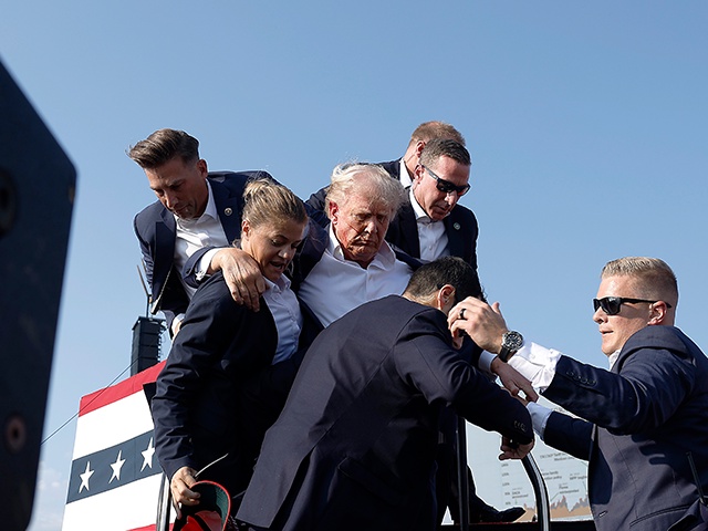 BUTLER, PENNSYLVANIA - JULY 13: Republican presidential candidate former President Donald Trump pumps his fist as he is rushed offstage during a rally on July 13, 2024 in Butler, Pennsylvania. Butler County district attorney Richard Goldinger said the shooter is dead after injuring former U.S. President Donald Trump, killing one audience member and injuring another in the shooting. (Photo by Anna Moneymaker/Getty Images)