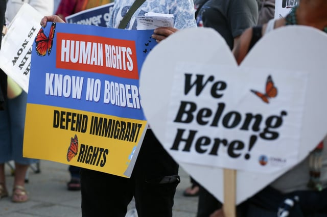 Protesters hold signs as they listen to speakers during a vigil and rally against recent US Immigration and Customs Enforcement raids in San Pedro on Friday, June 27, 2025. (Photo by Raphael Richardson, Contributing Photographer)
