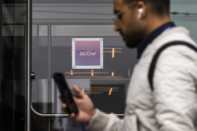 A pedestrian walks past technology startup Scale AI office in San Francisco. The company laid off 14% of its workforce just weeks after Meta invested $14.3 billion and hired its CEO Alexndr Wang.