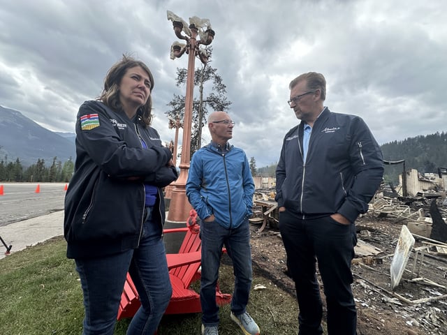 Premier Danielle Smith, Jasper Mayor Richard Ireland and Public Safety Minister Mike Ellis observing wildfire damage in Jasper, Alta. on Friday, July 26, 2024.