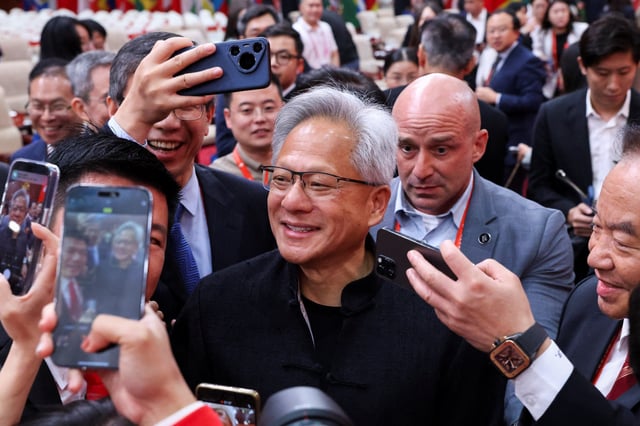 Nvidia CEO Jensen Huang is surrounded by media members after the opening ceremony for the China International Supply Chain Expo in Beijing, China July 16, 2025. REUTERS/Florence Lo/File Photo