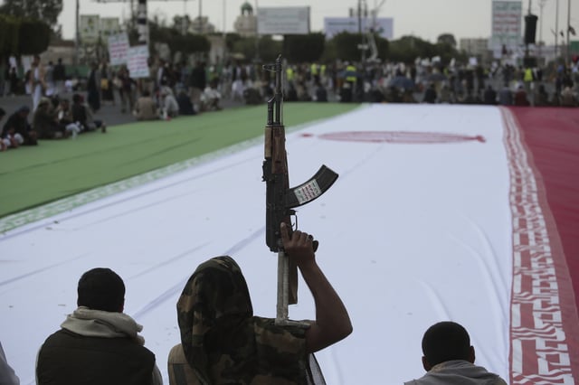 Houthi supporters surround a giant Iranian flag during an anti-U.S. and anti-Israel weekly rally in Sanaa, Yemen, Friday, June 20, 2025. (AP Photo/
