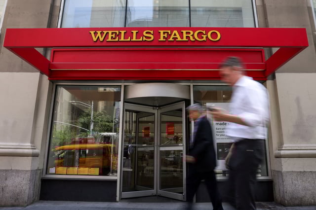 People walk by a Wells Fargo bank branch in New York City, U.S., June 4, 2025. REUTERS/Kylie Cooper/File Photo