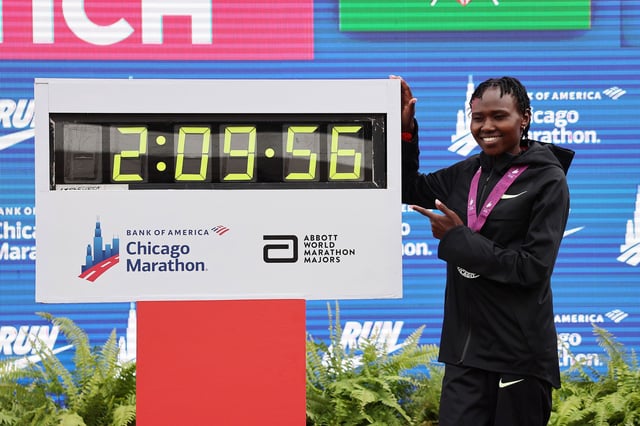 Ruth Chepngetich of Kenya poses with a clock after the 2024 Chicago Marathon professional women's division on October 13, 2024.