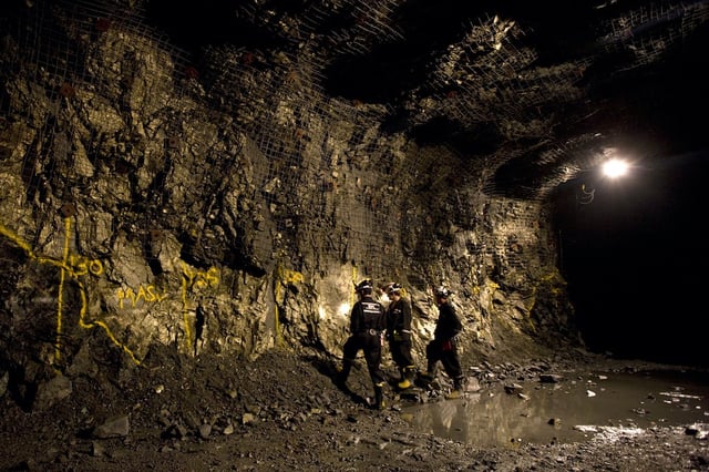 Examining an outcropping of a copper/nickel deposit 2750 feet below the surface at the Podolsky Mine, owned by the FNX Mining Company Inc., located in the Sudbury Basin, a 60 km by 30 km geological elliptical structure located north of the City of Greater Sudbury (400 km north of Toronto), Ontario, Canada Photographer: Norm Betts/Bloomberg News