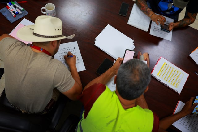 Mexican truck drivers attend an English class as part of an effort to comply with a recent executive order by U.S. President Donald Trump requiring commercial drivers to meet English proficiency standards, at the Fletes Sotelo company facilities in Ciudad Juarez, Mexico July 16, 2025. REUTERS/Jose Luis Gonzalez      TPX IMAGES OF THE DAY