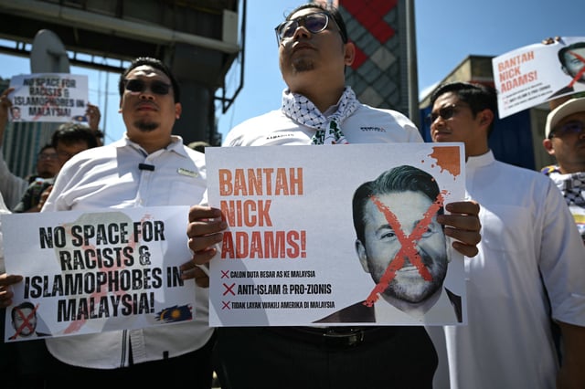 Protesters in Muslim-majority Malaysia hold signs during a demonstration against the US envoy nominee Nick Adams outside the US embassy in Kuala Lumpur on July 18, 2025. Trump nominated Nick Adams, an outspoken and self-proclaimed &#34;alpha male&#34; a week ago.