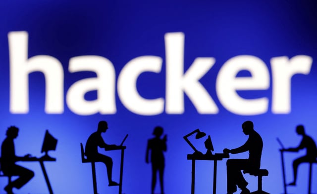 Figurines with computers and smartphones are seen in front of the word "hacker" in this illustration taken, February 19, 2024. REUTERS/Dado Ruvic/Illustration/File Photo